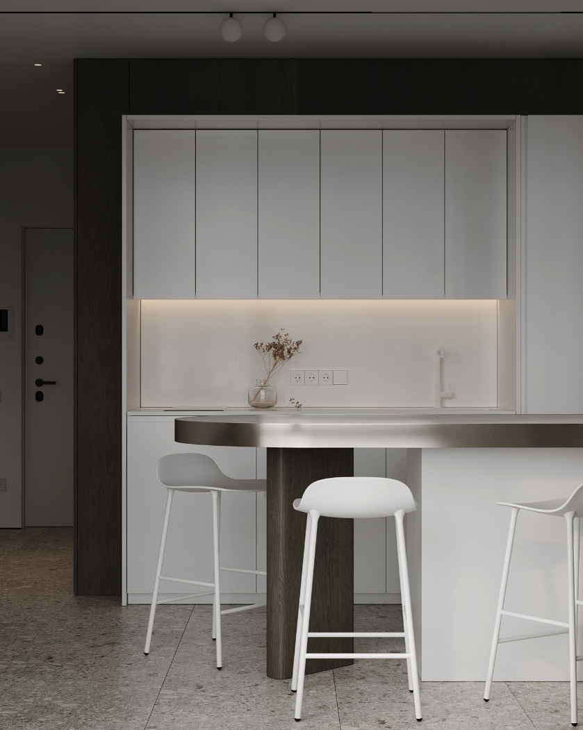 不銹鋼中島設計案例：不鏽鋼金屬圓弧桌板結合黑白簡約基座，搭配純白吧台凳與極簡櫥櫃，在灰色磨石子地坪的映襯下，展現前衛且俐落的冷調美學廚房空間。